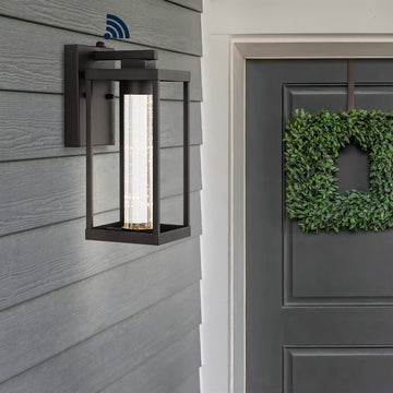 Juno 4.75" Industrial Vintage Iron/Glass Seeded Glass with Dusk-to-Dawn Sensor Integrated LED Outdoor Sconce - JONATHAN Y